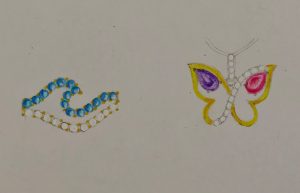 Jewelry design sketches of a ring shaped like an ocean wave on the left and a butterfly shaped pendant on the right