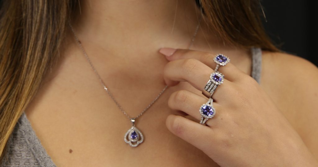 Close-up of tanzanite jewelry set including pendant and rings in white gold from Sophia Fiori’s December birthstone collection.
