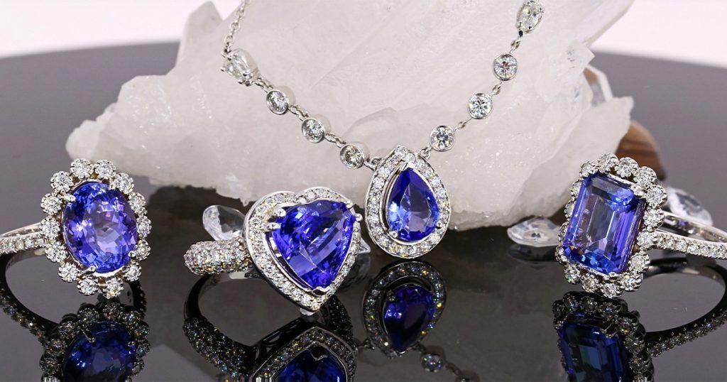 A showcase of exquisite Tanzanite jewelry including heart, pear, and emerald-cut gemstones framed by diamonds. The collection highlights the rare beauty and craftsmanship of Sophia Fiori designs.